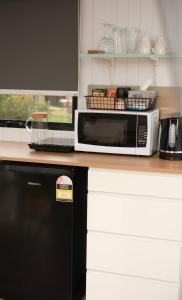 a microwave oven sitting on top of a kitchen counter at Starry Night Farmstay in Forbes
