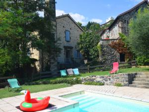 a swimming pool with a rubber duck in a yard at Lovely house with grass garden shared swimmingpool next to the river Ard che in Lalevade-dʼArdèche