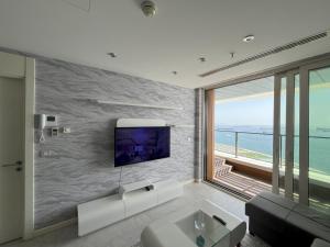 a living room with a tv on a wall at Marmara Magic: Jacuzzi Getaway in Istanbul