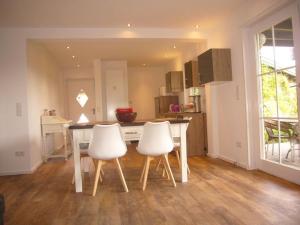 a kitchen with a table and two white chairs at Pleasant apartment in Münster in Münster