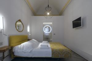 a bedroom with a bed and a mirror and a tv at La Casa del Poeta in Colle Val D'Elsa +36 photos