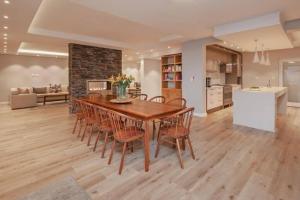 a kitchen and dining room with a wooden table and chairs at Waterstone Villa in Hermanus +45 photos