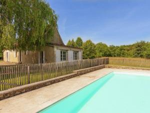 an empty swimming pool in front of a fence at Restored farmhouse with private pool in Campsegret