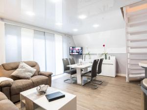 a living room with a couch and a table at Holiday home Villa Maiwaldo in Spieka-Neufeld