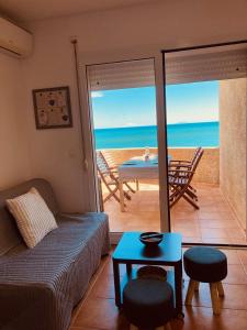 salon z kanapą i stołem w obiekcie Punta di Mare, appartements comme sur un bateau w mieście Linguizzetta