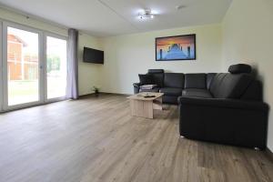 a living room with a couch and a table at Apartment Hafenflair am Plauer See Plau am See in Plau am See