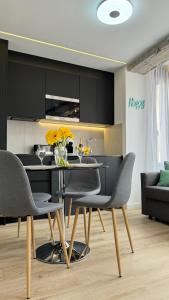 a kitchen with a table and chairs in a room at Apart-hotel Happy Life in Alicante