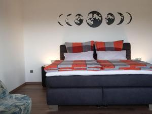 a bedroom with a bed with red and gray pillows at Holiday apartment Breit in Kirchdorf im Wald