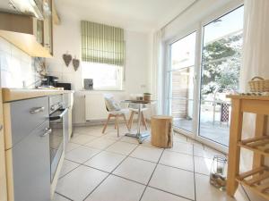 a white kitchen with a table and a table at Paradise in the paradise house in Sankt Englmar