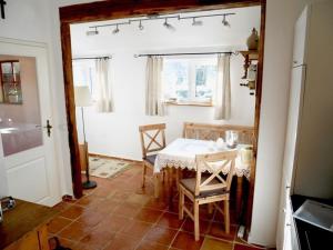 a kitchen with a table and chairs in a room at Holiday apartment wellness & relaxation in Wunsiedel