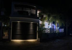 a building with a garage door at night at Jumelle Residence in Horetuduwa