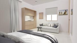 a living room with a bed and a couch at SKIATHOS MODERNO in Skiathos