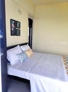 a bedroom with a bed with two pillows on it at 1 BHK Flat in Kochi 904 in Cochin