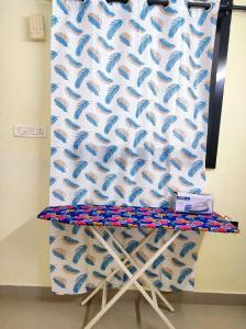 a curtain with blue fish on a wall at 1 BHK Flat in Kochi 904 in Cochin