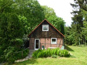 a small house in the middle of a field at Holiday home Wollspeicher in Gödenstorf
