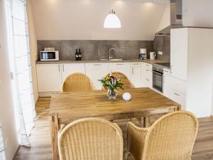 a kitchen with a wooden table and some chairs at Apartment in Oberkirch in Oberkirch +22 photos