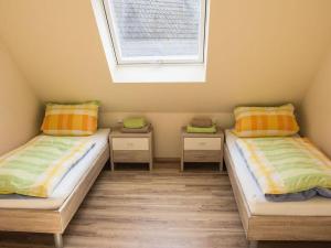 two twin beds in a room with a window at Apartment in Oberkirch in Oberkirch