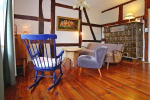 a living room with a blue rocking chair and a couch at Apartment Plau am See in Plau am See