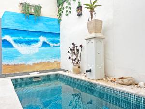 una piscina en una casa con una pintura en Casa Querida - Fuzeta, en Fuseta