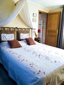 a bedroom with a large bed with red flowers on it at DUCK HOUSE in Saint-Wandrille-Rançon