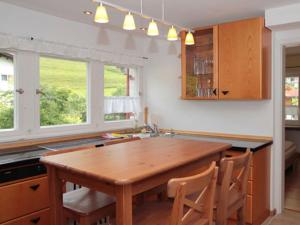 a kitchen with a wooden table and some windows at Fantastic apartment in Bad Hindelang in Bad Hindelang