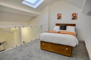 a bedroom with a bed and a skylight at 3 Bed Apartment in Wigan in Wigan