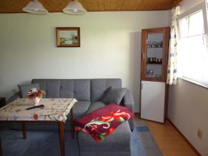 a living room with a couch and a table at Peaceful Apartment in Lichtenhain with Private Terrace in Lichtenhain