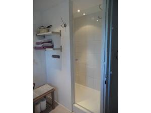 a shower with a glass door in a bathroom at Apartment on the mountain slope with balcony in Berchtesgaden