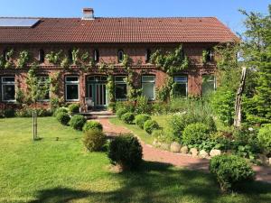 a brick house with a garden in front of it at 1 in the Maaßen country house in Stakendorf