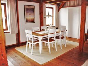 a dining room with a white table and chairs at 1 in the Maaßen country house in Stakendorf +27 photos