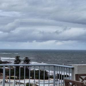 a view of the ocean on a cloudy day at Kings Beachside Escape spacious apartment centrally located in Caloundra +23 photos