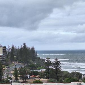 a view of the ocean on a cloudy day at Kings Beachside Escape spacious apartment centrally located in Caloundra