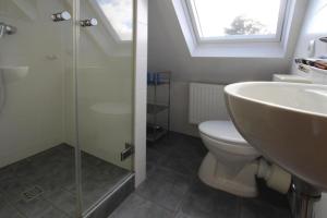 a bathroom with a sink and a toilet and a shower at Apartment house Katharina Westerland in Westerland (Sylt)