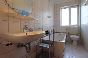 a bathroom with a sink and a toilet at Apartment house Katharina Westerland in Westerland (Sylt)