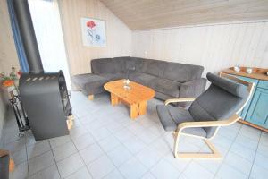 a living room with a couch and a table at Cottage in Granzow at 500 m from the lake in Mirow