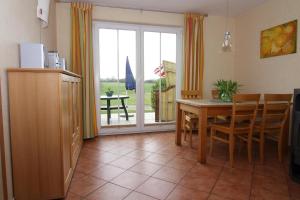 a kitchen and dining room with a table and chairs at Semi detached house Kuehlungsborn in Kühlungsborn