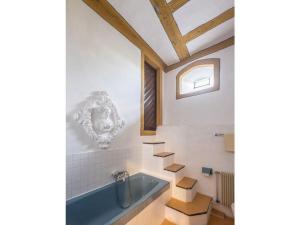 a bathroom with a blue tub and a window at Lovely apartment in Unsleben in Unsleben