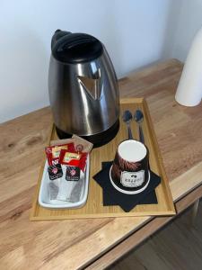 a table with a coffee pot and a cake on it at Hostal Boutique La Malagueña - Only Adults in Estepona