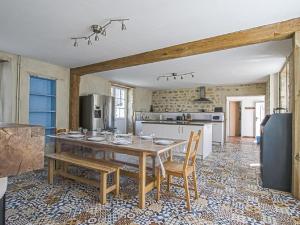 een keuken met een tafel en stoelen in een kamer bij Beautiful holiday home in Isigny sur Mer with garden in Isigny-sur-Mer