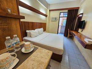Postel nebo postele na pokoji v ubytování Tsai Hotel and Residences + 37 fotografií