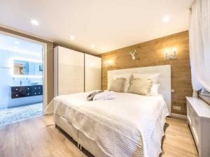 a bedroom with a large white bed and a window at Holiday apartment Wellness Lodge in Wernigerode