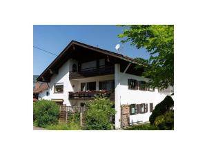 a white apartment building with a balcony and trees at Holiday apartment Rosi Denz in Bad Au