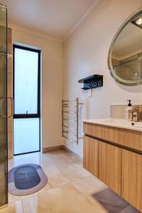 a bathroom with a sink and a mirror at Cozy Retreat on Serene Street in Hamilton