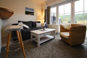 a living room with a couch and a chair and a table at Apartment Garding in Garding