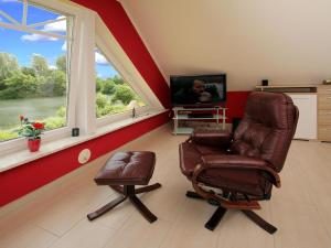 sala de estar con silla y TV en Apartment house at Kiessee Westerholt, en Westerholt