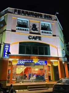 a building with a carental hotel in front of it at Ferringhi Inn Hotel in Batu Ferringhi