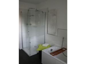 a white bathroom with a shower and a tub at Holiday home Sweden house in Kaarßen