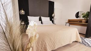 a bedroom with a bed with white sheets and a table at Ferienwohnungen Krüger 'Apartment Marina' in Gammelsbach