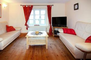 a living room with two couches and a coffee table at Terraced houses in the port village of Vieregge on the island of R gen in Vieregge