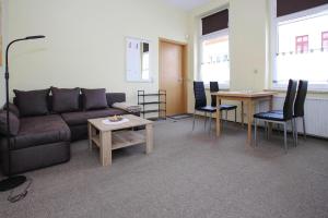 a living room with a couch and a table and chairs at Apartment in Malchow with terrace in Malchow